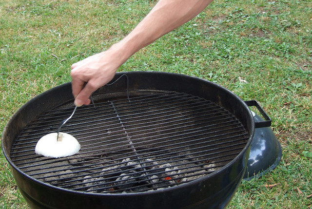 Clean grill with aluminum foil and onion